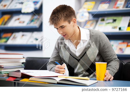 Handsome male student in a university library Handsome male student in a university library 9727166