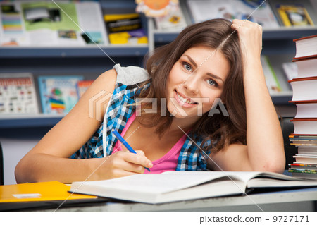 Beautiful female student in a university library Beautiful female student in a university library 9727171