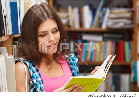 Beautiful female student in a library Beautiful female student in a library 9727197