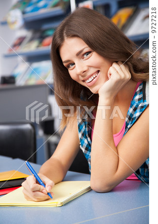 Beautiful female student in a university library Beautiful female student in a university library 9727218