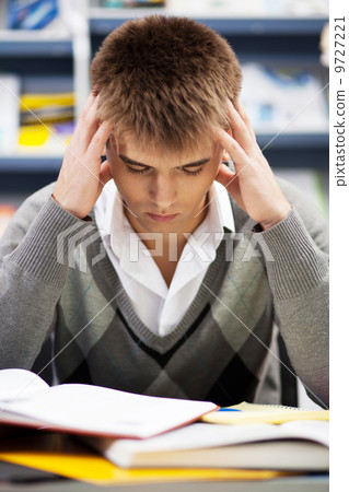 Handsome male student in a library Handsome male student in a library 9727221