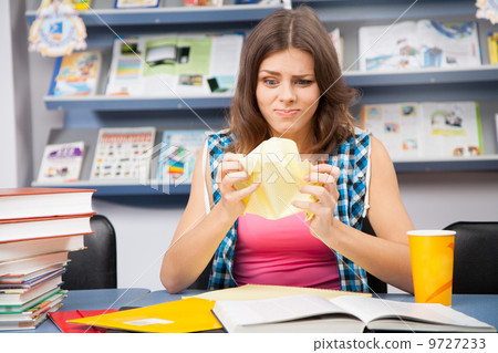 Stressed female student in a library Stressed female student in a library 9727233