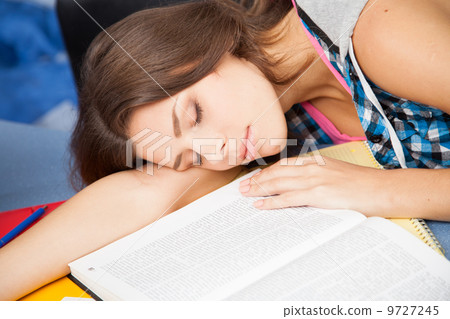 Beautiful female student in a library Beautiful female student in a library 9727245