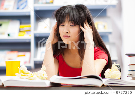 Beautiful female student in a library Beautiful female student in a library 9727250