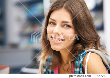 Beautiful female student in a library Beautiful female student in a library 9727269