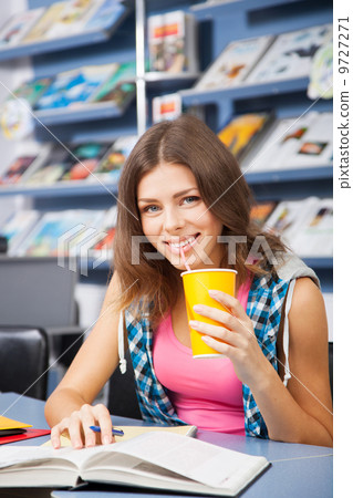 Beautiful female student in a library Beautiful female student in a library 9727271