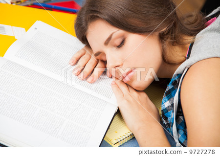 Beautiful female student in a library Beautiful female student in a library 9727278