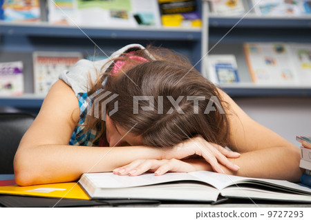 Beautiful female student in a library Beautiful female student in a library 9727293