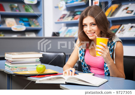 Beautiful female student in a university library Beautiful female student in a university library 9727305