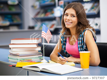 Beautiful female student in a library Beautiful female student in a library 9727307