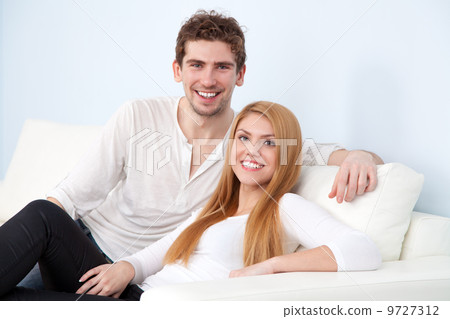 Young beautiful couple on a sofa at home Young beautiful couple on a sofa at home 9727312