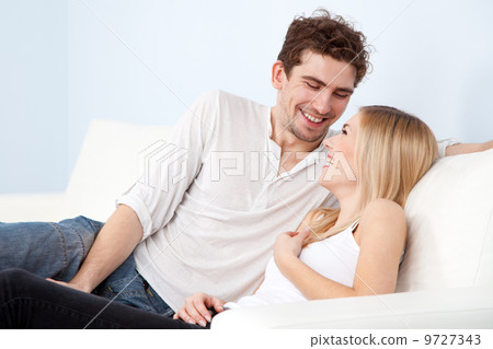Young beautiful couple on a sofa at home 9727343