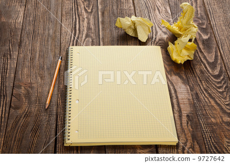 Notepad on a wooden table Notepad on a wooden table 9727642