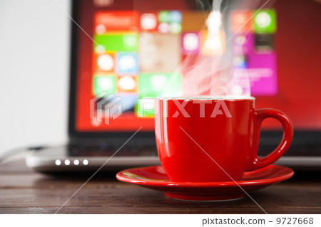 Laptop and a cup of coffee Laptop and a cup of coffee 9727668