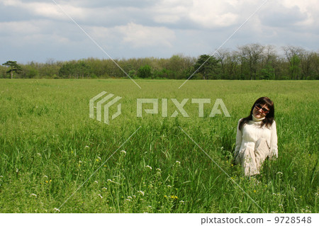 Young woman lying on green grass 9728548