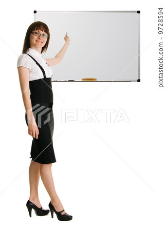 Young woman in businesssuit pointing on whiteboard Young woman in businesssuit pointing on whiteboard 9728594