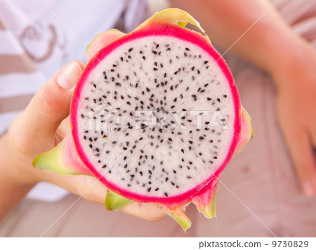 Woman holding a dragon fruit Woman holding a dragon fruit 9730829