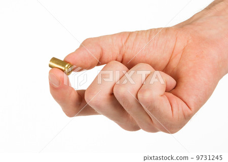 Hand holding an empty bullet shell Hand holding an empty bullet shell 9731245