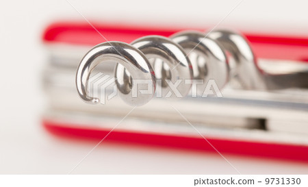 Red swiss army knife isolated, focus on corkscrew 9731330