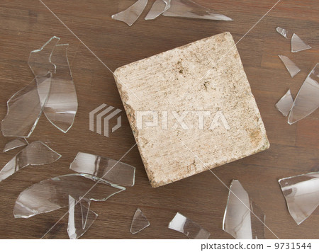 Brick with broken glass, violence concept Brick with broken glass, violence concept 9731544