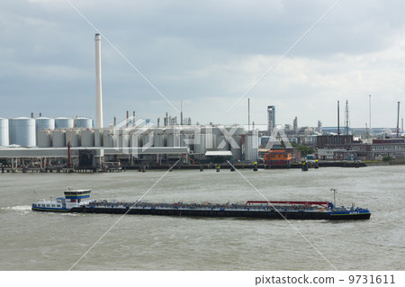 Small chemical tanker sailing in the port of Rotterdam (Holland) Small chemical tanker sailing in the port of Rotterdam (Holland) 9731611