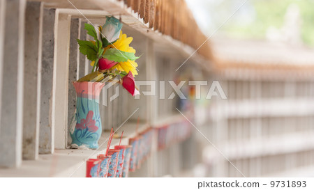 Collection of fake plastic flowers at a cemetary Collection of fake plastic flowers at a cemetary 9731893
