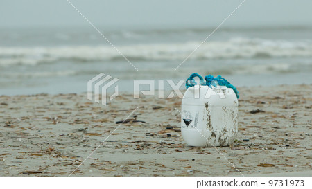 Container with acid on a beach 9731973
