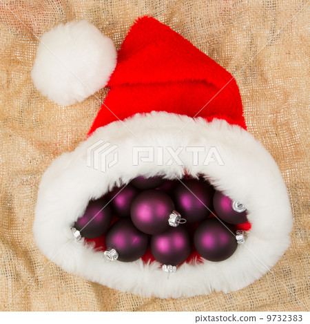 Santas hat filled with Christmas balls Santas hat filled with Christmas balls 9732383