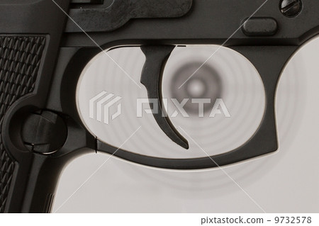The trigger of a handgun with a shooting target The trigger of a handgun with a shooting target 9732578