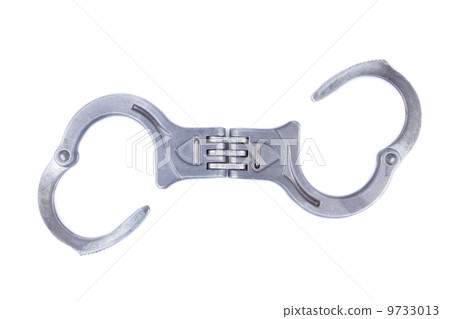 Metal handcuffs isolated on a white background Metal handcuffs isolated on a white background 9733013