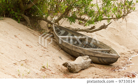 Small rowing boat on the shore of a small river Small rowing boat on the shore of a small river 9733014