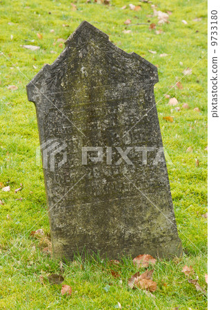 A tombstone on an old graveyard A tombstone on an old graveyard 9733180