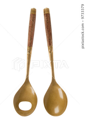Old brass serving spoons isolated 9733379