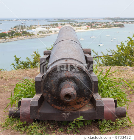 Very old rusted canon pointing at a bay Very old rusted canon pointing at a bay 9733422