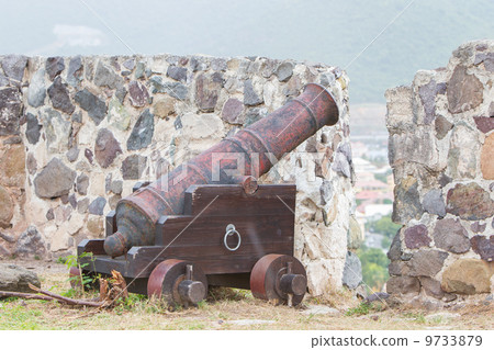 Very old rusted canon on top of an old wall Very old rusted canon on top of an old wall 9733879