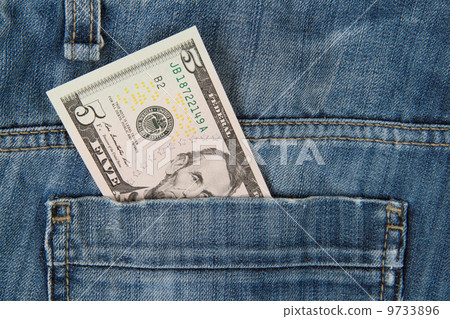 Macro shot of trendy jeans with american 5 dollar bill Macro shot of trendy jeans with american 5 dollar bill 9733896