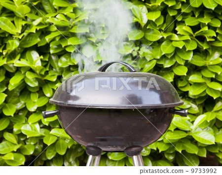 Old black barbecue being used 9733992