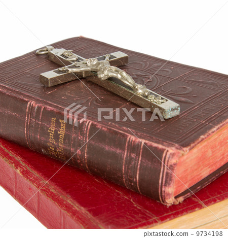 Old antique bible and cross on a white background Old antique bible and cross on a white background 9734198