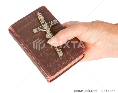 Old hand (woman) holding a very old bible Old hand (woman) holding a very old bible 9734227