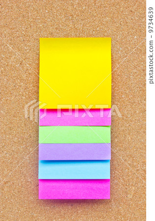 Six colorful sticky notes on wooden board. 9734639
