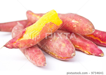 Heap of red yams. one root was peeled. 9734641