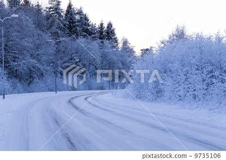 Winter forest with road covered with snow Winter forest with road covered with snow 9735106
