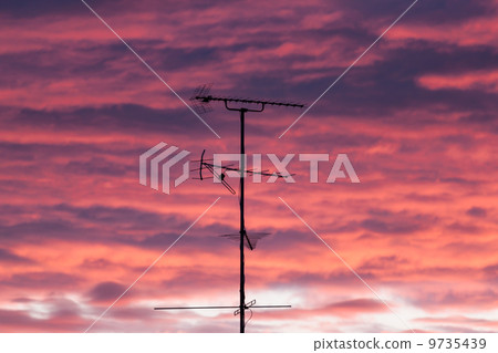 silhouettes of antennas with sunset 9735439