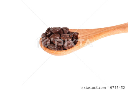 Coffee beans on wooden spoon 9735452