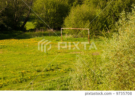 Rural soccer field with white goal posts 9735708