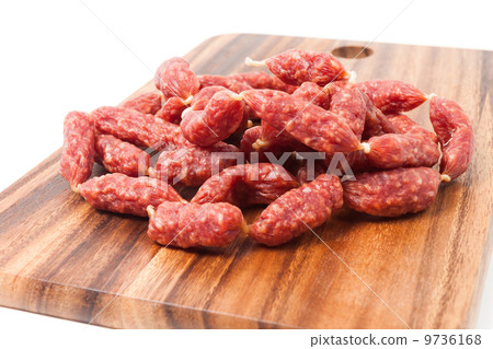 A heap of mini Salamis on wooden board A heap of mini Salamis on wooden board 9736168