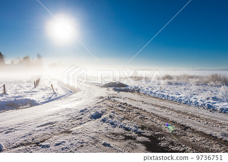 winter landscape at fog  with road 9736751