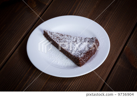 Chocolate Cake Slice on white dish 9736904