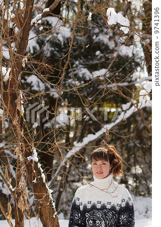 A girl in the winter forest 9741396