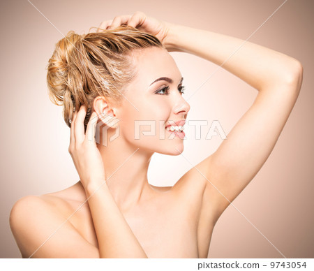 Portrait of an young woman washing her hair 9743054